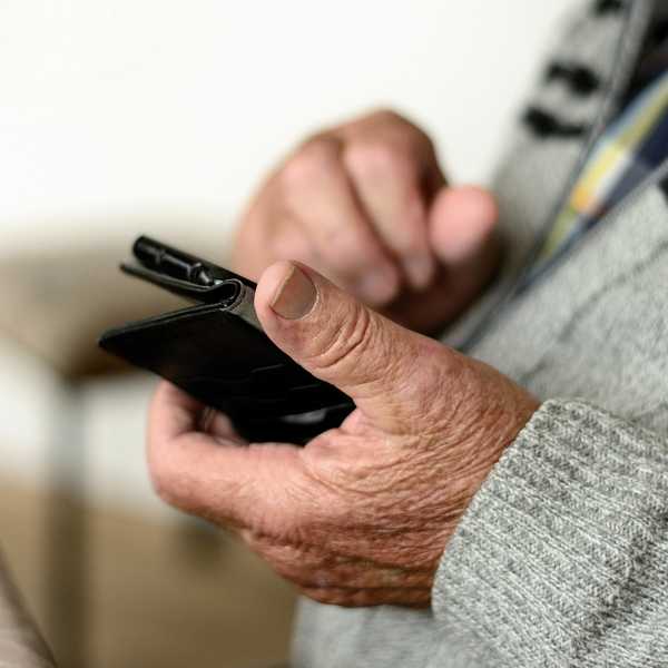 mobile in hand of older person